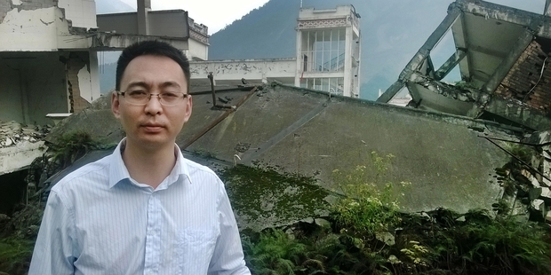 Liu Zhihong, mayor of Yingxiu, stands among the ruins of the Xuankou Middle School.