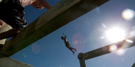 A boy dives off the wharf at Omapere in the Hokianga Harbour.