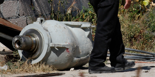 A firefighter stands next to the radiation head that was part of a radiation therapy machine,. Photo / AP