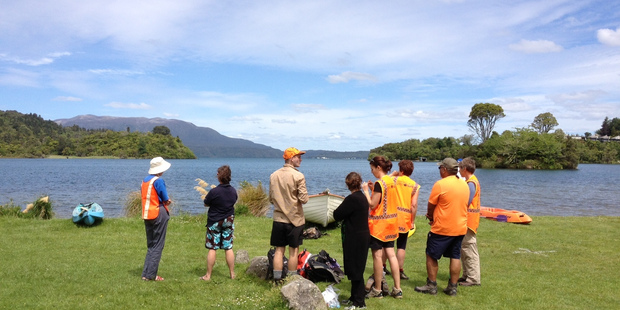 Search and rescue team members on the shore of Lake Tarawera. Photo / Christine Cornege