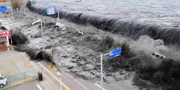 The tsunami gushes over the breakwater protecting the coastal city of Miyako.
Photo / AP