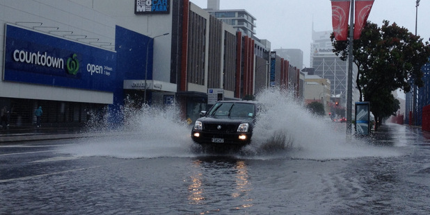 Flooding in Quay Street, Auckland. Photo / Chris Gorman
