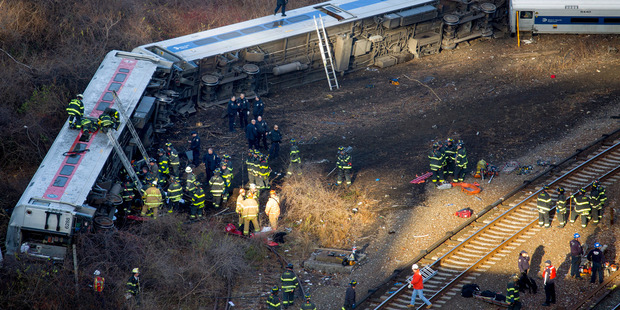 First responders work the scene of a derailment of a Metro-North passenger train in the Bronx. Photo / AP