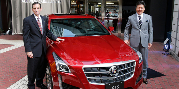 Sumito Ishii, managing director of General Motors Japan, right, and Gregg Sedewitz, director of sales and marketing, pose with a new Cadillac CTS during a press conference in Tokyo. Photo / AP