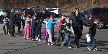 Police lead a line of children from the Sandy Hook Elementary School in Newtown. Photo / AP