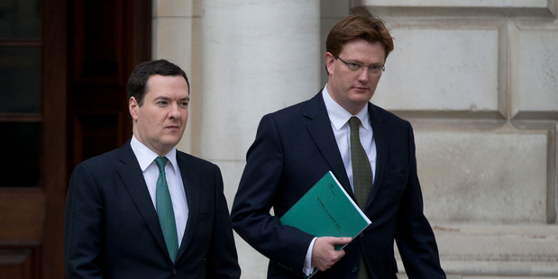 Britain's Chancellor of the Exchequer George Osborne, left, and his deputy the Chief Secretary to the Treasury Danny Alexander, leave the Treasury. Photo / AP