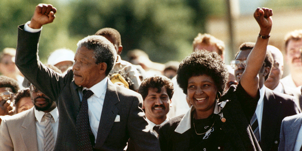 Nelson Mandela and his wife, Winnie, raise clenched fists as they walk hand-in-hand upon his release from prison in Cape Town, South Africa. Photo / AP