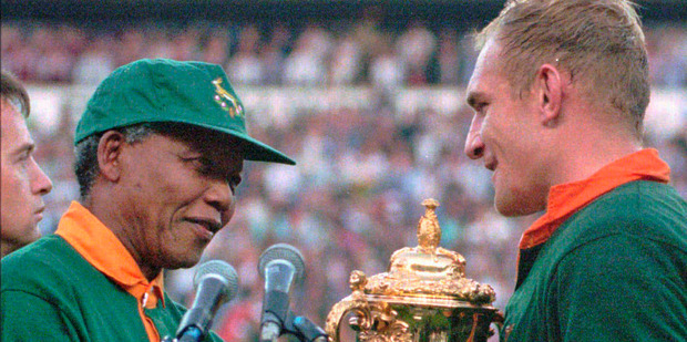 South African rugby captain Francios Pienaar receives the Rugby World Cup from Nelson Mandela. Photo / AP