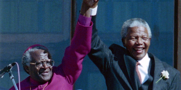 Desmond Tutu, right, hailed Nelson Mandela, right, as a great unifier following his death today. Photo / AP