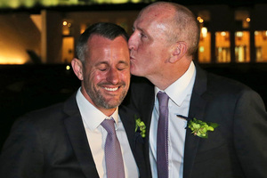 Western Australian politician Stephen Dawson, right, gives his husband Dennis Liddelow a kiss after they married in front of Parliament House. Photo / AP