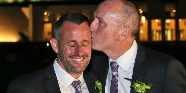 Western Australian politician Stephen Dawson, right, gives his husband Dennis Liddelow a kiss after they married in front of Parliament House. Photo / AP