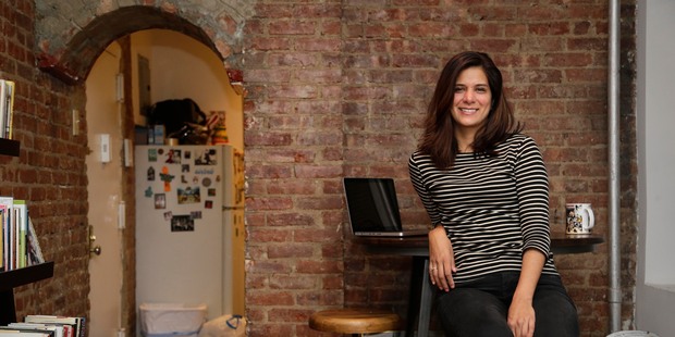 Mishelle Farer poses for a photo in her New York apartment, one room of which she rents out on Airbnb. Photo / AP
