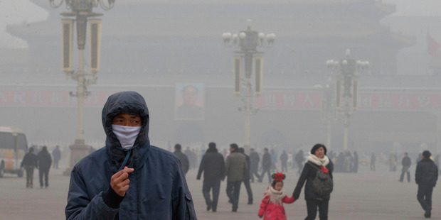 A man wears a mask on Tiananmen Square in thick haze in Beijing. Photo / AP
