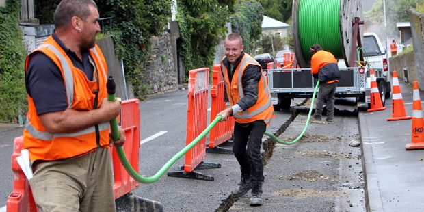 Rolling out fibreoptic cable cover. Photo / Glenn Taylor