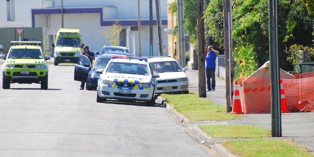 Paramedics and police make their way to a Cole St property in Masterton where a man died suddenly yesterday morning. PHOTO/NATHAN CROMBIE