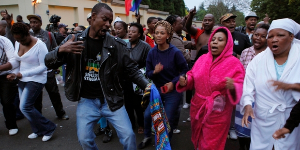 A group of mourners sing and dance outside Nelson Mandela's Johannesburg home. Photo / AP