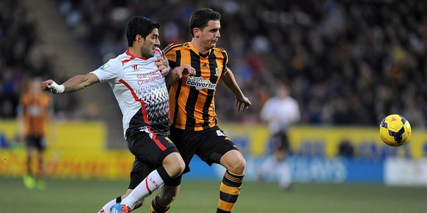 Hull City's Alex Bruce, right, and Liverpool's Luis Suarez tussle during Hull City's historic win. Photo / AP