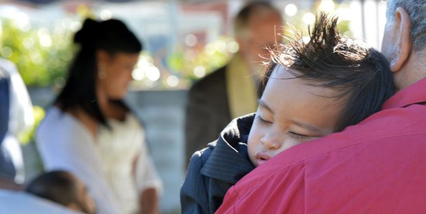 Benjamin Paulo sleeps on a guest's shoulder during the marriage ceremony of his parents, Jesse and Lafoaluga Paulo, at the Otago Community Hospice. Photo / Stephen Jaquiery