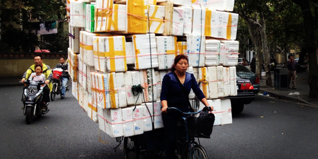 Commercial deliveries by bicycle pedallers are common sights in densely populated Shanghai. It may keep costs down but it looks to be an exhausting way to earn a living. Photo / Daniel Richardson