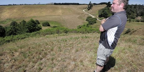 Dairy farmer Jonathon Boyle and his dry paddocks in Pongakawa. Photo / George Novak