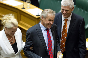 The Speaker elect, David Carter, is dragged to his chair by Government whips, Louise Upston and Tim Macindoe after the vote in Parliament. Photo / Mark Mitchell