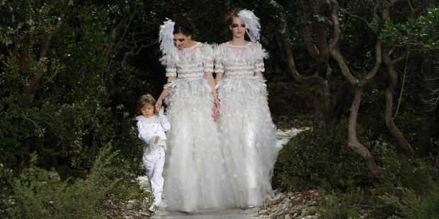 Ashleigh Good (right) is the first NZ model to close for Chanel. The brides walked in the Spring Summer 2013 Haute Couture collection in Paris this month. Photo / AP