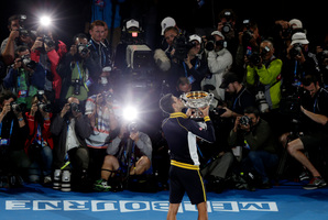 Novak Djokovic holds the Australian Open trophy after beating Andy Murray of Britain yesterday. Photo / AP
