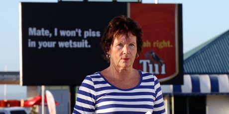 Barbara Mckelvie standing in front of the billboard she made an official complaint about. Photo / Duncan Brown