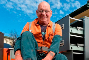 Roger Parsons removes his work boots for the last time yesterday. Photo / Stephen Jaquiery