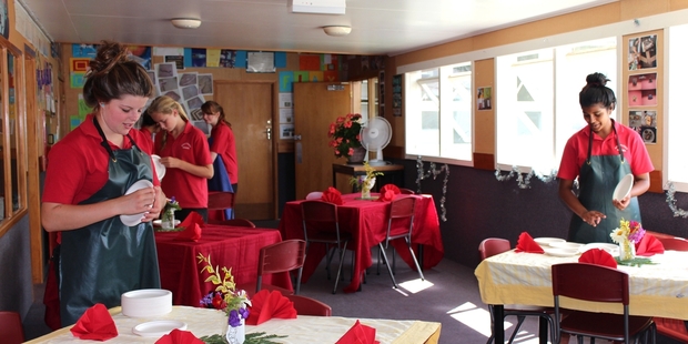 MANY HANDS: Julia Ryan, Danielle Turton, Laura Holmes and Tanya Narayan decorate the festival cafe tables.
