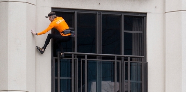 Alain Robert scaling the Metropolis yesterday. Photo / Greg Bowker