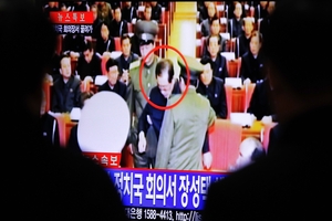 Jang in civilian clothes (above) as he is seized by guards. Photo / AP