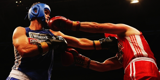 Chris Cairns (blue) and Simon Doull put on a spirited display at the Fight for Life last night. Photo / Getty Images