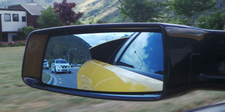 A police car follows the Lamborghini. Photo / Louise Taylor