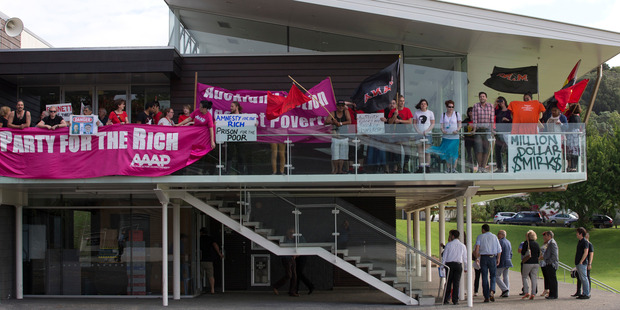 Police try and control protesters at the National Party's Christmas function. Photo / Greg Bowker