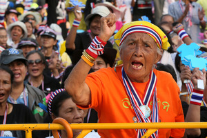 An elderly Thai woman shouts anti-government slogans during a rally at the Democracy Monument in Bangkok. Photo / AP
