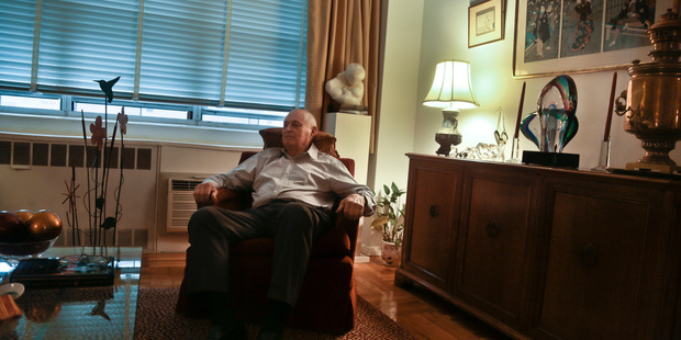 Morton Chalek, 91, a WWII vet and a victim of Bernie Madoff's massive Ponzi scheme, listens during an interview in the apartment he shares with another victim. Photo / AP