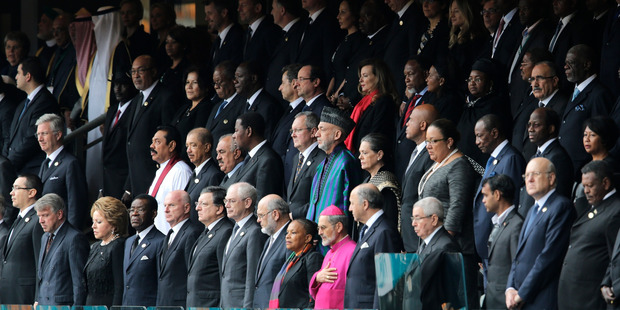 VIP's and dignitaries stand up for the start of the memorial service for former South African president Nelson Mandela. Photo / AP