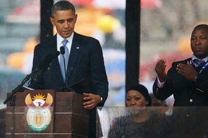 President Barack Obama looks down as he stands next to the sign language interpreter as he makes his speech at the memorial service. Photo / AP