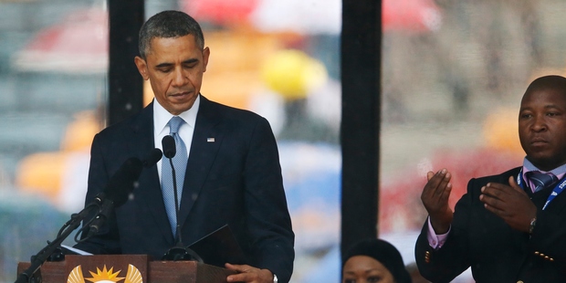 President Barack Obama looks down as he stands next to the sign language interpreter as he makes his speech at the memorial service. Photo / AP