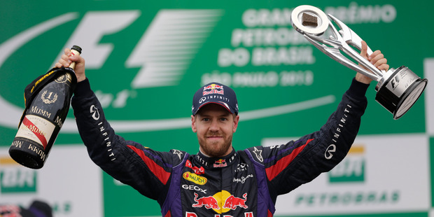 Red Bull driver Sebastian Vettel of Germany holds up the trophy after winning the Brazilian Formula One Grand Prix at the Interlagos racetrack in Brazil. Photo / AP