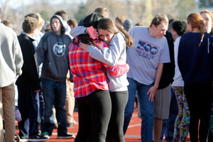 Students comfort each other at Arapahoe High School in Colorado. Photo / AP Ed Andrieski