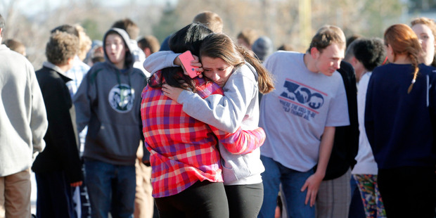 Students comfort each other at Arapahoe High School in Colorado. Photo / AP Ed Andrieski
