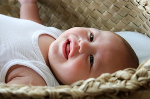 A baby in a wahakura, a safe sleeping space, to help prevent Sudden Unexpected Death in Infancy (SUDI). Photo / Whakawhetu