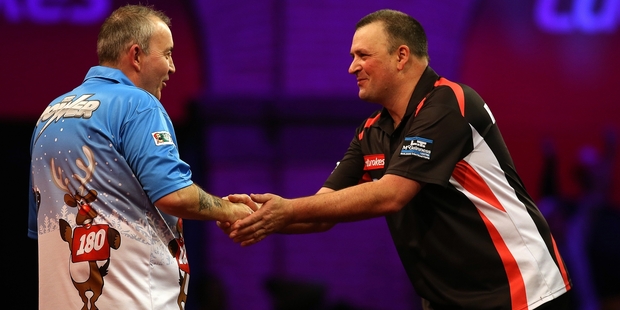 Sixteen-times world champion Phil Taylor, left, is congratulated by New Zealander Rob Szabo. Photo / Getty Images