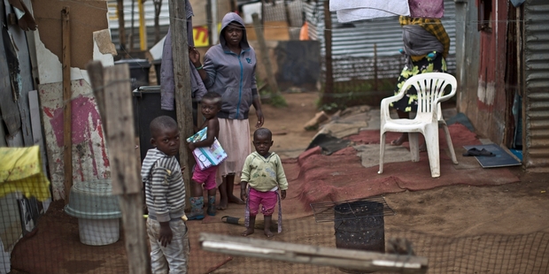 Living conditions in many poor, crowded townships are a far cry from the sumptuous homes in grand suburbs. Photo / AP