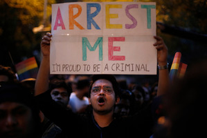 An Indian gay rights activist holds up a placard during a protest. Photo / AP