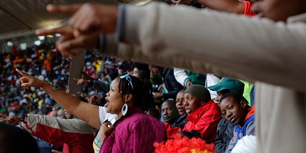 People sing songs during the memorial service for former South African president Nelson Mandela. Photo / AP