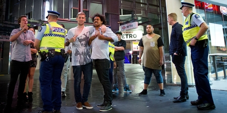 Police speak to young people in Queen St in the early hours of Thursday. Photo / Sarah Ivey