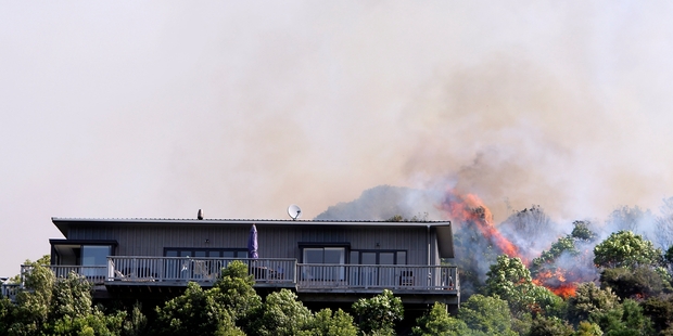 Flames close to a home in Tumbledown Bay Rd, Port Underwood, near Picton. Photo / Andrew Lucas
